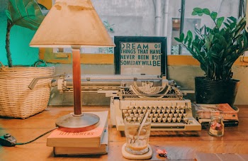 Lighted Table Lamp Beside Typewriter