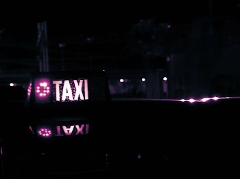 Lighted Taxi Sign at Night