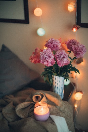 Lighted Tealight Candle Near Pink Carnation Flowers