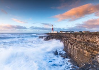 lighthouse near sea during daytime