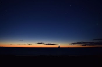 lighthouse on body of water