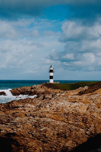 Lighthouse on Rocky Island during Day