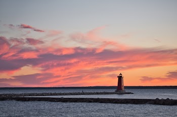 Lighthouse Surrounded by Body of Water