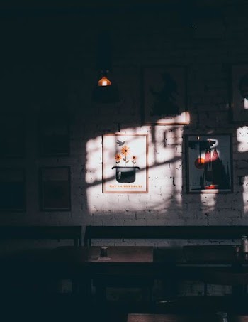 lights casting on photo frames in dark room