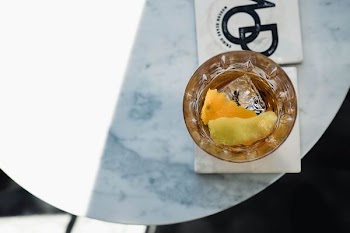 liquid in shot glass on top marble table