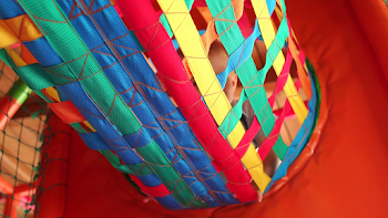 Little boy crawling on colorful hanging tunnel in the Playground ...