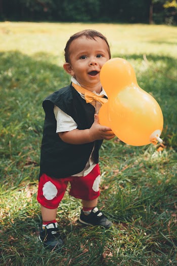 Little Boy Holding Yellow Balloon