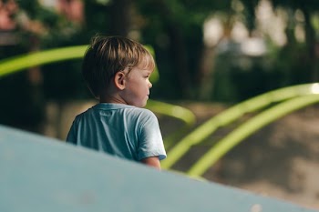 Little Boy In Playground Looking To The Right