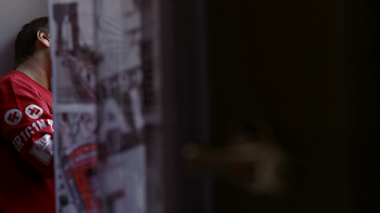 little boy playing alone in his bedroom with the glass of the ...