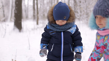 Little children play with blades for snow in winter in the Park ...