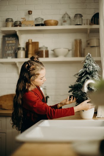 Little Girl Checking On A Christmas Tree 