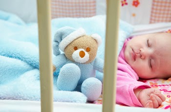 little girl in crib