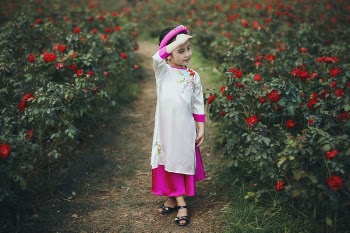 Little girl in rose garden