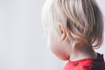 Little girl looking out the window