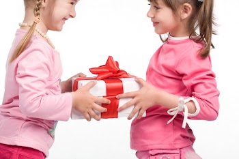 Little girls holding white gift boxes