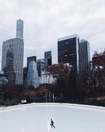 Lone Person Ice Skating Under Heavy Clouds