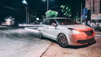 Long Exposure Photography of Silver Suzuki Dezire on Road
