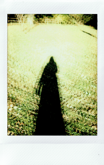 Long Shadow of a Person on the Grass