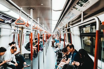 lots of people riding electric train