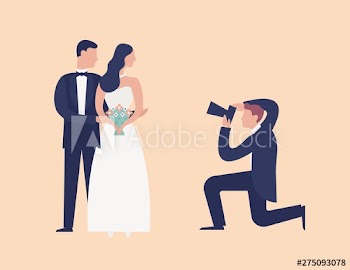 Lovely newlyweds standing together and posing for photographer shooting them