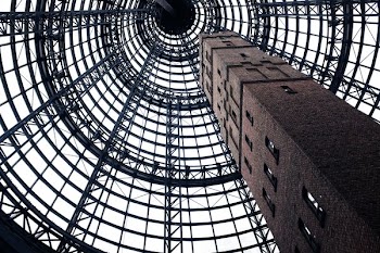 low-angel photography of gray concrete tower with windows