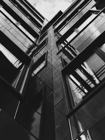 Low Angle Grayscale Photo of Highrise Building