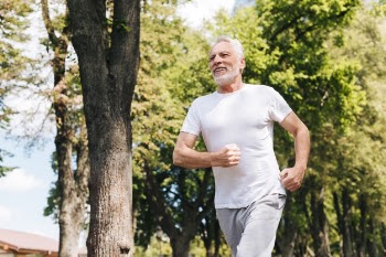 Low angle old man running outdoors Free Photo