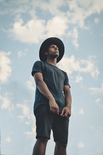 Low Angle Photo Man in Black T-shirt, Shorts and Fedora Hat