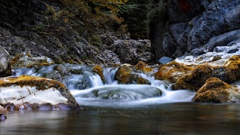 Low Angle Photo Of A Body of Water Near Rocks