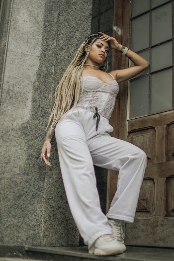 Low-Angle Photo of a Woman Leaning on Wall