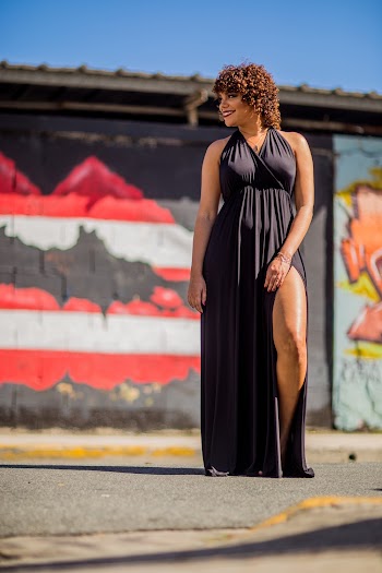Low Angle Photo Of A Woman Wearing Black Halterneck Side-slit Dress