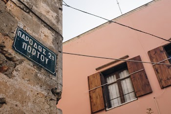 Low Angle Photo of Alley With Signage on Brick Wall