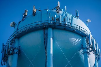 low angle photo of blue metal tank