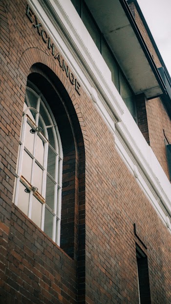 Low-angle Photo of Brick Building With Closed Glass Window