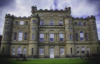 Low Angle Photo of Brown Castle Surrounded by Green Grass