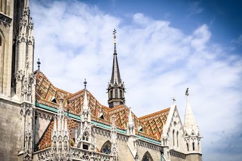 low angle photo of brown, white, and gray cathedral