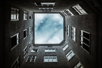 Low Angle Photo of Building Under Clouds