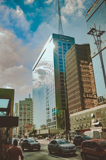 Low-angle Photo of Buildings Near Car Passing Through