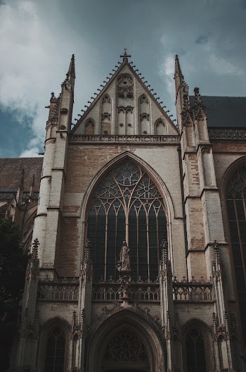 Low-Angle Photo of Church Under Cloudy Sky