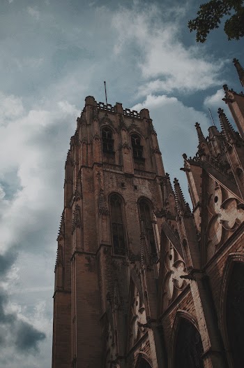 Low-Angle Photo of Church Under Cloudy Sky