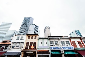 low angle photo of city buildings and stores during daytime