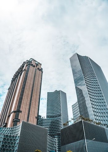 low angle photo of curtain wall buildings at daytime