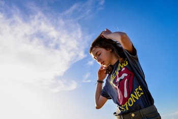 Low Angle Photo of Girl Raising Her Both Arms