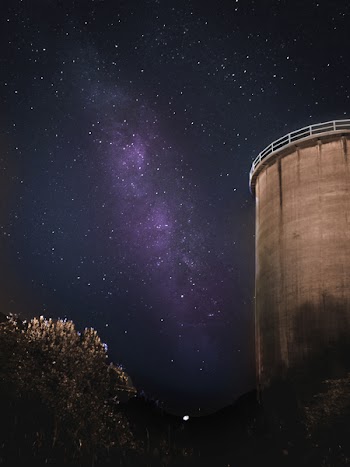 Low-angle Photo of Gray Concrete Building Under Starry Night