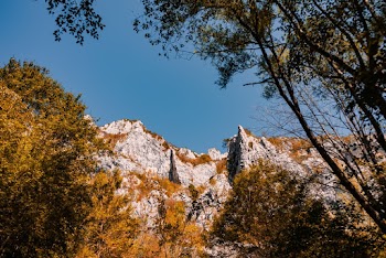 Low Angle photo Of  Gray Stone Cliff Mountain Peaks