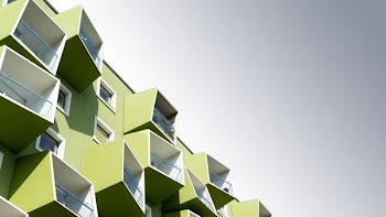 low angle photo of green and white concrete building