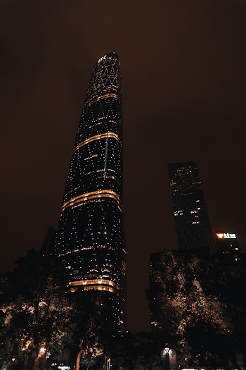 Low Angle Photo Of High-Rise Building During Nighttime