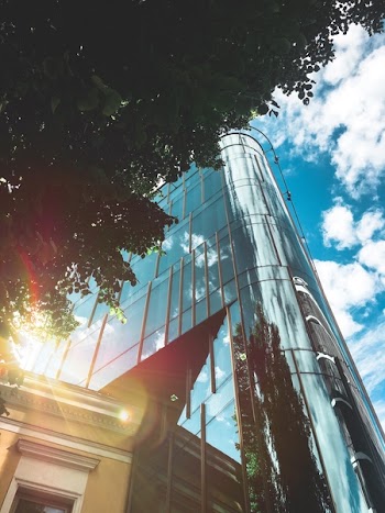 Low Angle Photo of High-rise Building over Blue and Cloudy Sky at Daytime