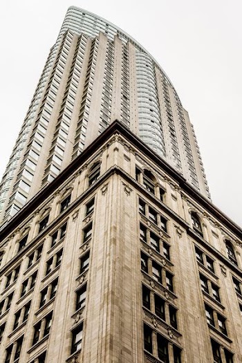 low angle photo of high rise building under gray sky