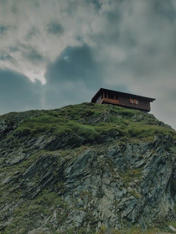 Low Angle Photo Of House On Top Of The Cliff